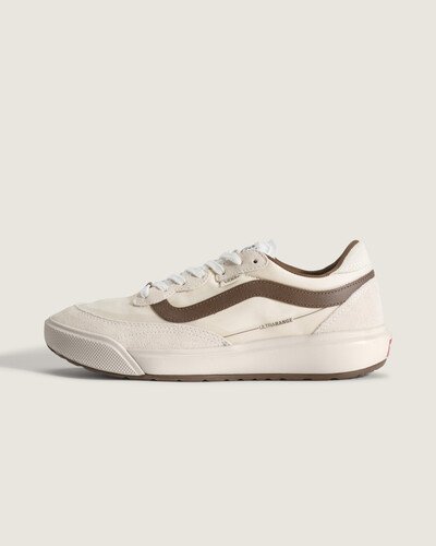 A família UltraRange nasceu como resposta da Vans à necessidade de um tênis versátil para longas jornadas. O modelo Tênis Ultrarange Se 2.0 Marshmallow Brown combina acabamento em couro com sobreposições em camurça e construção cold cement, entregando conforto e leveza. Sola de borracha com padrão de tração amplia a aderência, enquanto o bico redondo, a sidestripe discreta e o acolchoamento no tornozelo oferecem suporte e flexibilidade.